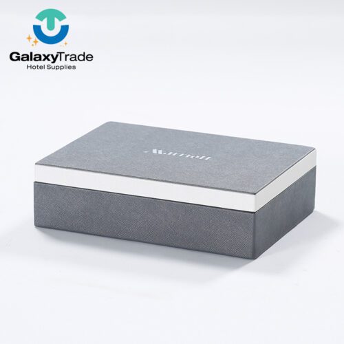 A Marriott Shanghai Luwan branded luxury hotel stationery box in grey faux leather with a white lid trim and rectangular profile.