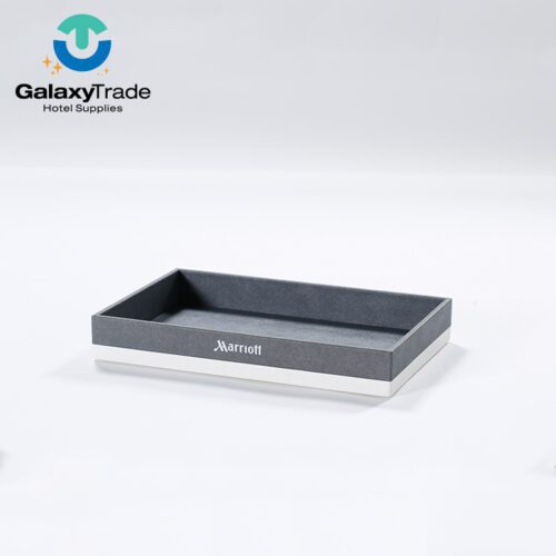 A Marriott Shanghai Luwan branded luxury hotel amenity tray in grey faux leather with a white base and a neat rectangular profile.
