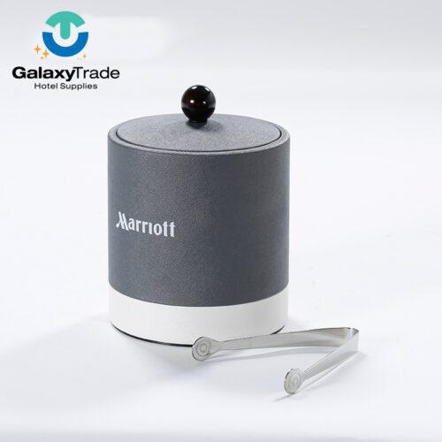 A Marriott Shanghai Luwan branded luxury hotel ice bucket in grey faux leather with a white base, lid, and stainless steel tongs.