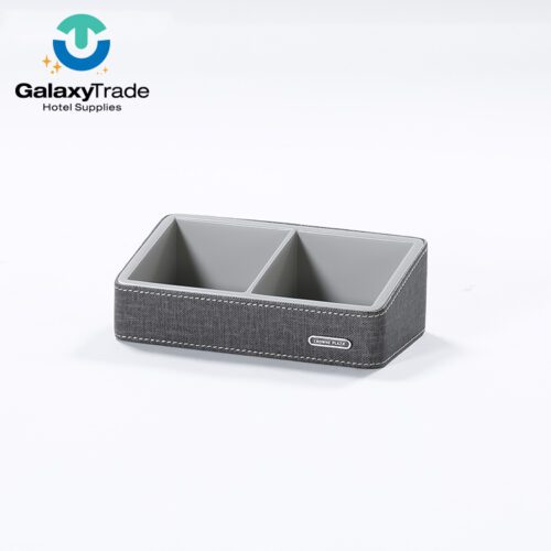 A Crowne Plaza branded luxury hotel remote control holder in grey textured faux leather with two compartments.