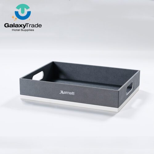 A Marriott Shanghai Luwan branded luxury hotel room tray in grey faux leather with integrated handles and a white base.