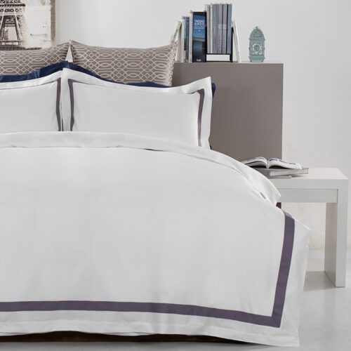 Modern sunflower yellow hotel bedding set with bold navy blue contrast borders and matching flanged pillowcases.