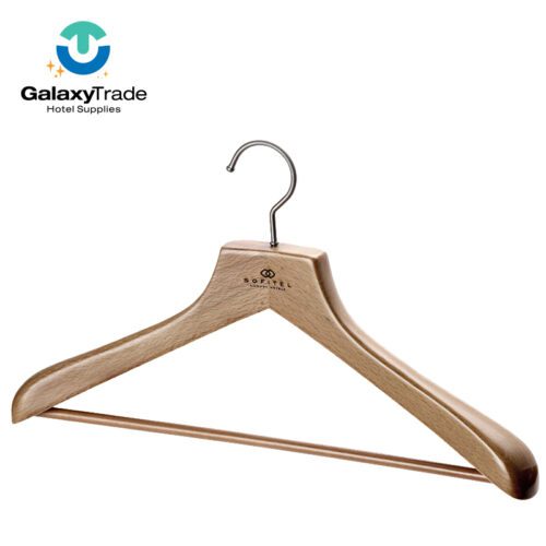 A professional product shot of a Sofitel branded natural finish solid wood hotel hanger with a trouser bar and chrome hook.