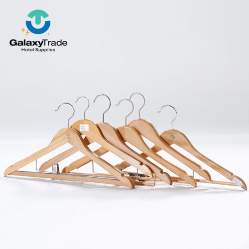 A professional display of various natural beech wood hotel hangers custom branded with the Sofitel logo.