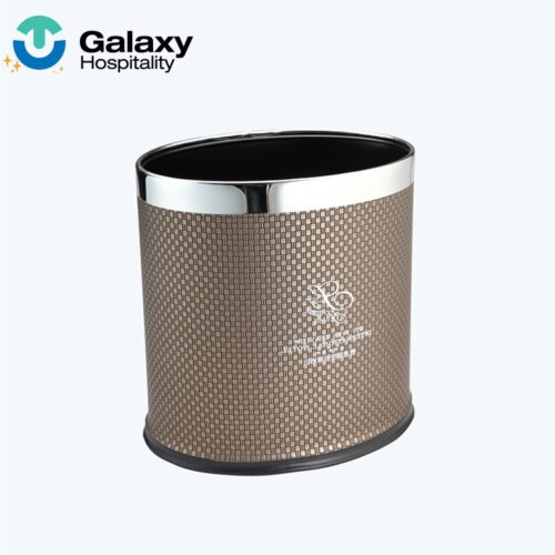 A professional product shot of an Oval Faux Woven Leather Waste Basket featuring a light brown weave pattern and a silver metallic rim.