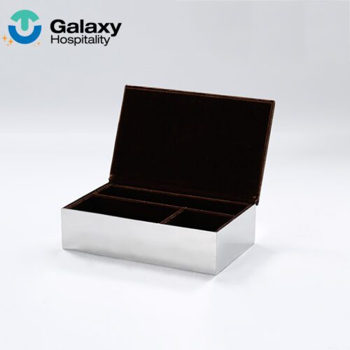A high-resolution shot of an open Stainless Steel Guest Room Organizer Box featuring a mirror-finish exterior and a three-compartment dark velvet interior.