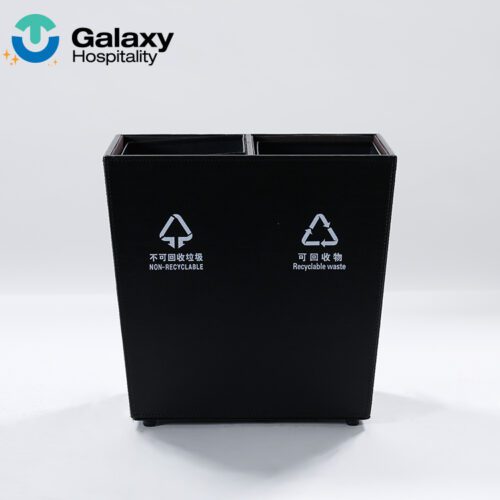 A front-facing studio shot of a black Dual-Compartment Leather Waste Recycler with white recycling and non-recycling icons.