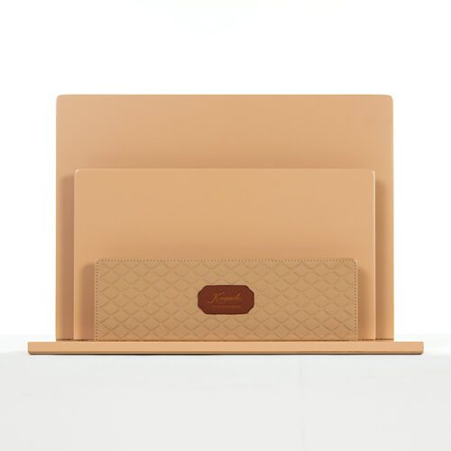 A professional front-facing shot of a Kempinski branded three-tier beige faux leather magazine and document holder.