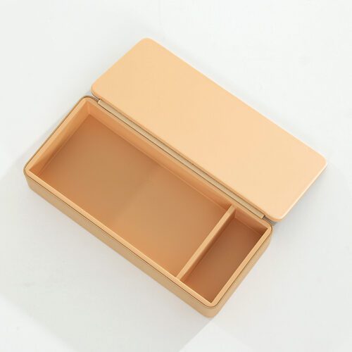 A professional product shot of an open Kempinski branded beige faux leather rectangular storage box with a hinged lid and internal divider.