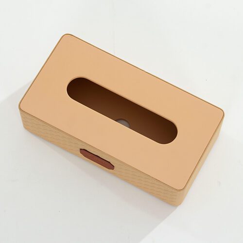 A top-down professional product shot of a Kempinski branded beige faux leather rectangular tissue box cover with a diamond-patterned side texture.