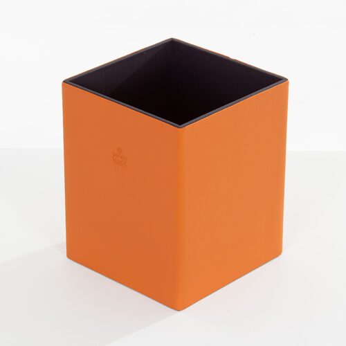 A Braira branded square vibrant orange faux leather waste basket with a deep purple interior lining.