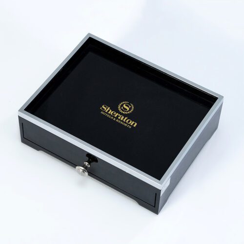 A Sheraton branded luxury hotel drawer-style storage box in black faux leather with silver trim and a metallic pull knob.