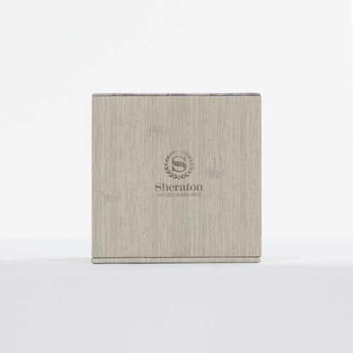 A Sheraton branded luxury hotel tissue box cover featuring a grey linen-textured faux leather wrap in a boutique square design.