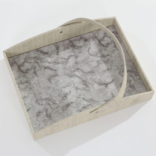 A Sheraton branded luxury hotel serving tray featuring a grey marble-textured base and a grey linen-textured leather rim with a handle.