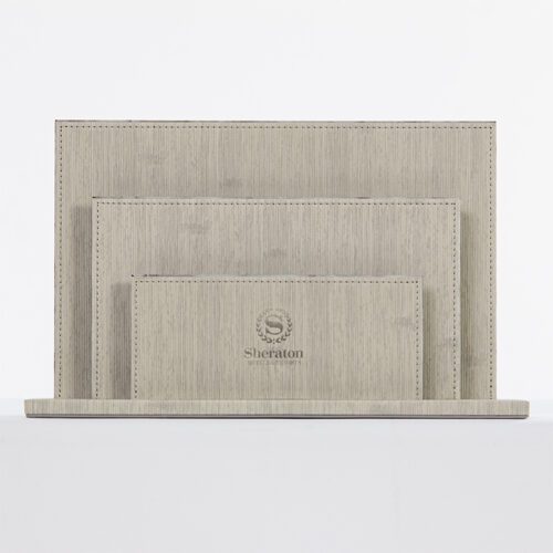 A Sheraton branded three-piece luxury desktop organizer set featuring tiered grey linen-textured faux leather folders and stationery holders.