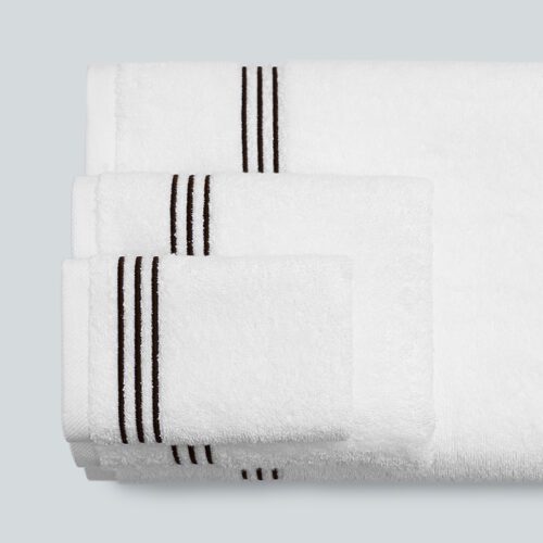 A stack of three premium white plush cotton towels featuring a sophisticated triple black stripe embroidered border.