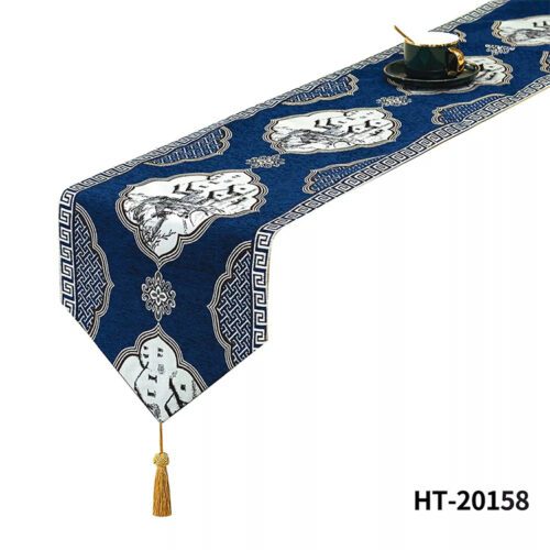 A navy blue Chinese style bed runner with traditional landscape ink-painting medallions and a gold tassel.