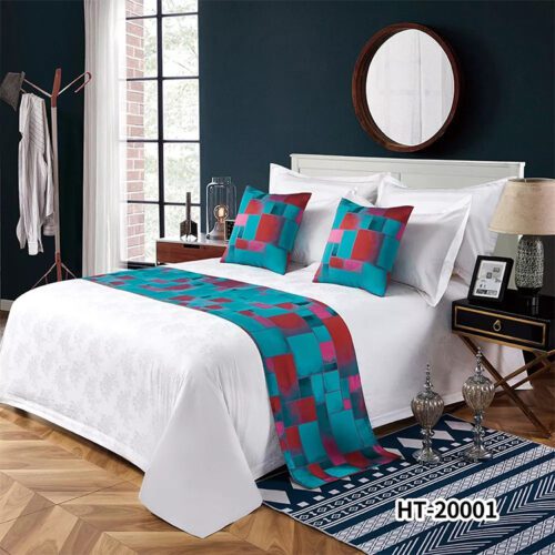 A modern bedroom featuring a white bed with a teal and red geometric patterned runner and matching pillows.