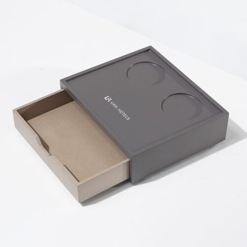 A professional product view of a UAN HOTELS branded matte grey storage box with an open drawer and top cup holders.