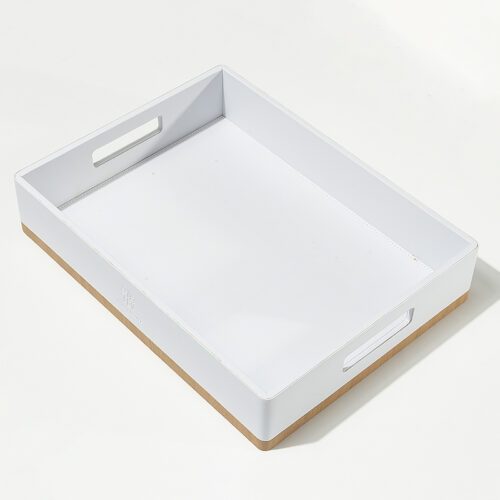 A professional product shot of a Banyan Tree branded white leather and natural wood hotel serving tray with handles.