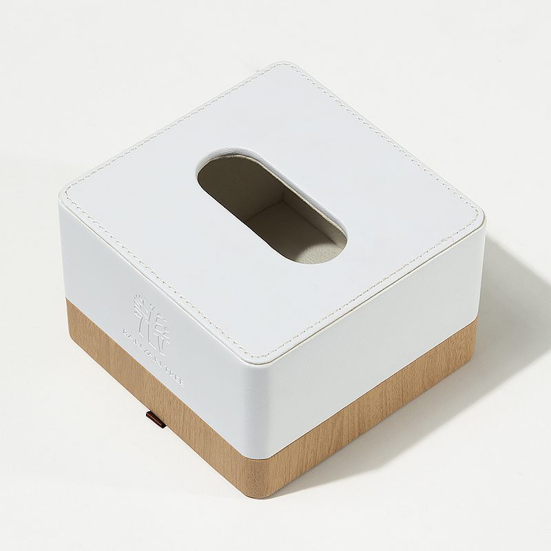 A professional product shot of a Banyan Tree branded square tissue box featuring a white leather top and natural wood bottom.