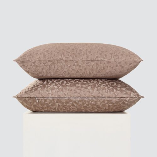 A stack of two premium taupe throw pillows featuring an intricate 3D low-poly geometric faceted pattern and a smooth satin finish.