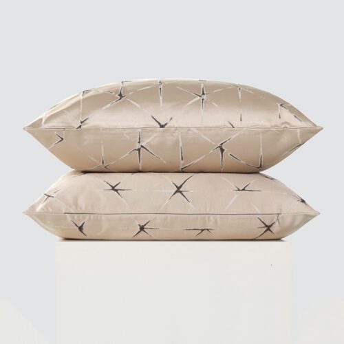 A high-resolution product shot of a stack of two Minimalist Beige Linear Throw Pillows featuring a subtle grey shibori-inspired linear pattern and a smooth satin finish.