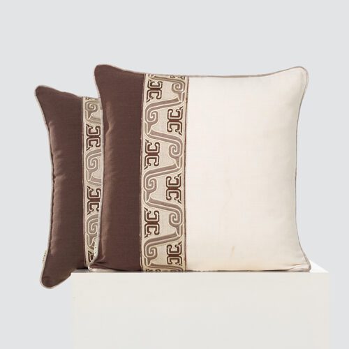 A high-resolution product shot of a pair of Coffee Brown and Cream Color Block Cushions featuring a bold vertical color block and an intricate central embroidered geometric decorative panel.