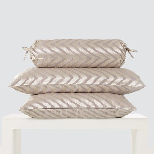 A high-resolution product shot of a Champagne Gold Chevron Bolster and Pillow Set featuring one decorative neckroll and two rectangular cushions.