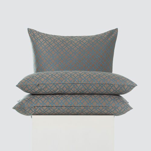 A high-resolution product shot of a three-piece Warm Taupe and Teal Quatrefoil Embroidered Pillow set featuring a teal geometric pattern and a matte taupe background.