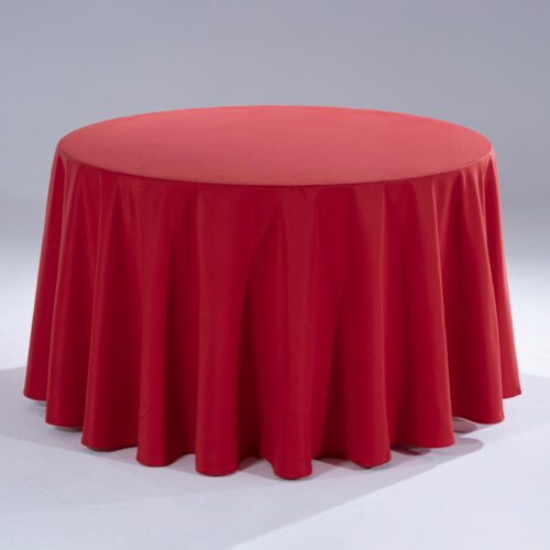 A large, vibrant red 100% pure cotton round tablecloth draped elegantly over a banquet table in a professional studio.