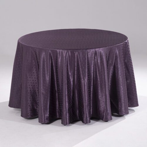 A large purple round polyester tablecloth with an intricate snowflake jacquard pattern draped over a banquet table.