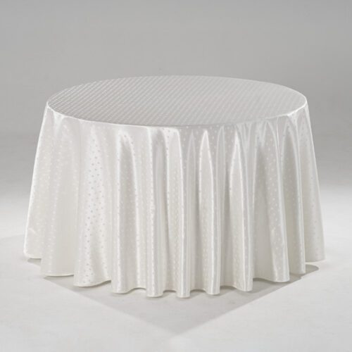 A large white round polyester tablecloth with an intricate snowflake jacquard pattern draped over a banquet table.