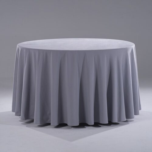 A large, modern grey 100% pure cotton round tablecloth draped elegantly over a banquet table in a professional studio setting.