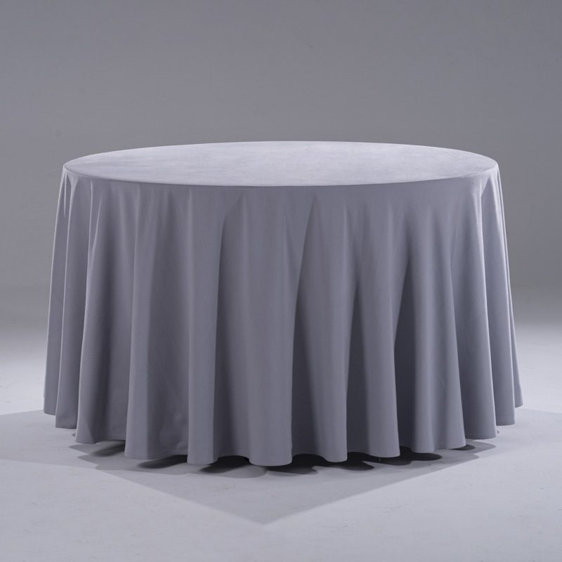 A large, modern grey 100% pure cotton round tablecloth draped elegantly over a banquet table in a professional studio setting.
