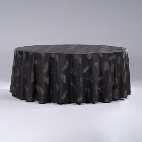 A large black round polyester tablecloth with elegant metallic gold feather jacquard patterns draped over a banquet table.