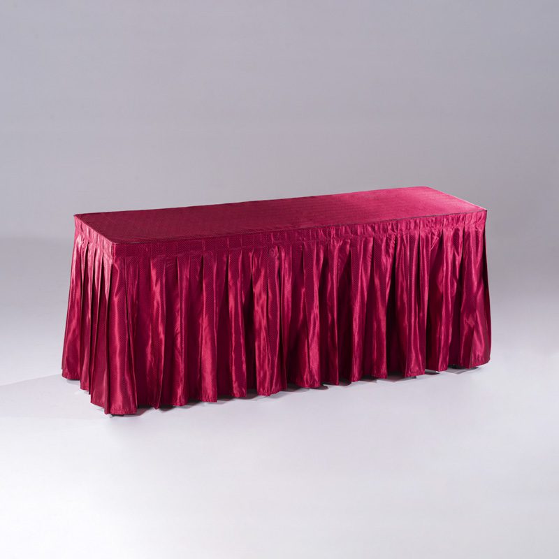 A long rectangular red polyester tablecloth with an intricate "Raindrop" jacquard pattern draped over a banquet table.