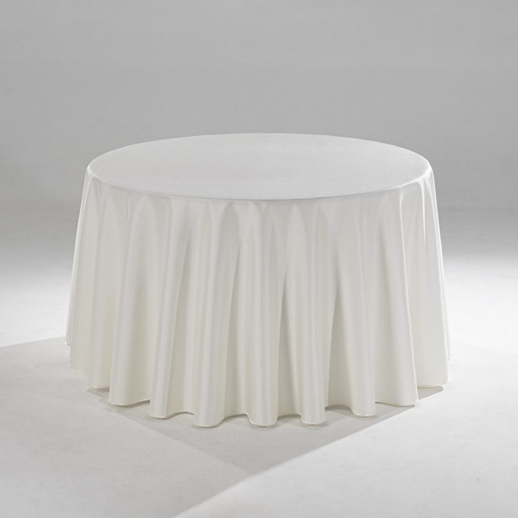A large white round polyester tablecloth with a subtle raindrop jacquard pattern draped over a banquet table in a professional setting.