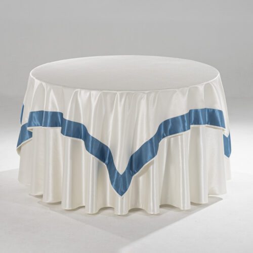 A round white hotel tablecloth featuring a decorative teal satin pointed border overlay.
