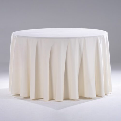 A large white seamless polyester round tablecloth draped elegantly over a banquet table in a professional studio setting.