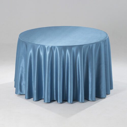 A large blue round polyester tablecloth with a subtle raindrop jacquard pattern draped over a banquet table in a professional setting.