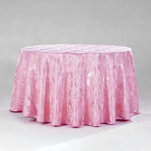 A large romantic pink round polyester tablecloth with an intricate floral jacquard pattern draped over a banquet table.