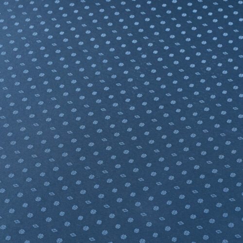 Close-up view of the blue jacquard weave showing the intricate and symmetrical snowflake-inspired textured motifs.