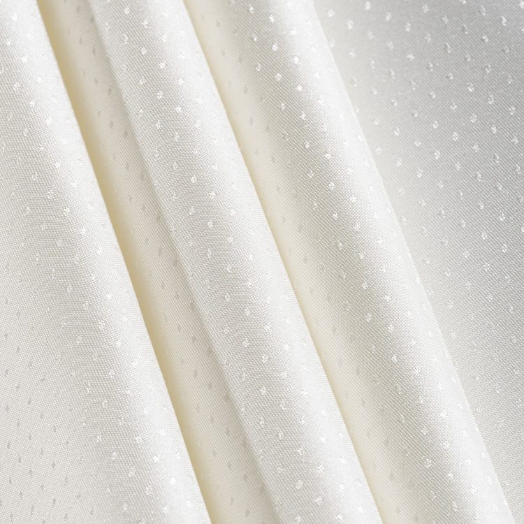 Close-up detail of the "Raindrop" jacquard weave showing the textured pattern on premium white polyester fabric.