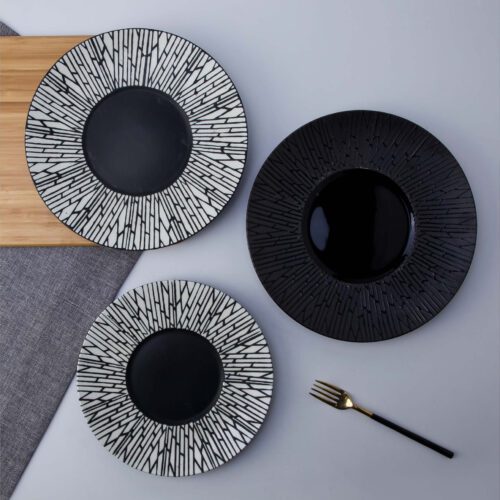 Three modern porcelain dinner plates featuring a black and white radial cracked texture pattern on a neutral background.