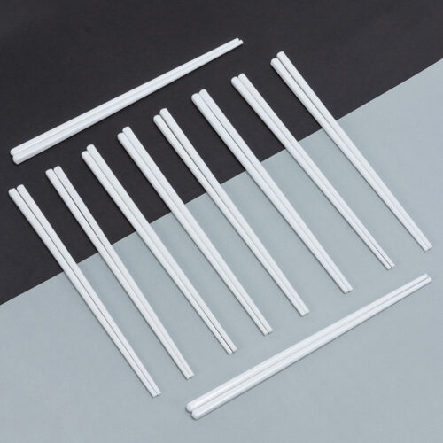 Galaxy white reusable porcelain ceramic chopsticks set neatly arranged on a modern black and light grey diagonal background.