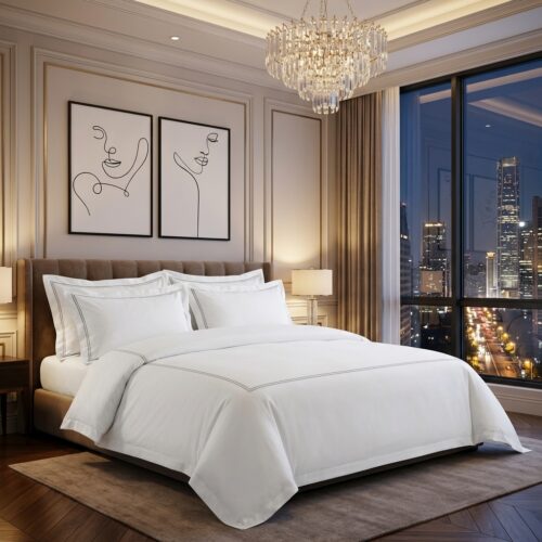 A luxury high-rise hotel king bed dressed in a white bedding set with grey double-line embroidery detail against a night city skyline backdrop.