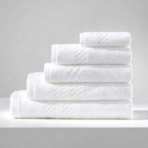 Stack of five folded white 100% cotton hotel towels with a textured checkerboard jacquard border.