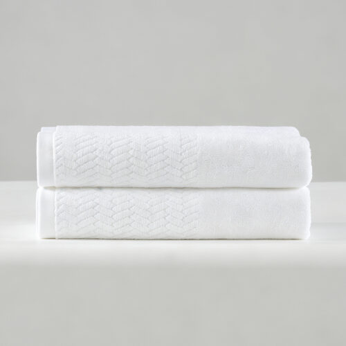 Folded stack of two white 100% cotton hotel towels featuring a textured herringbone jacquard woven border.