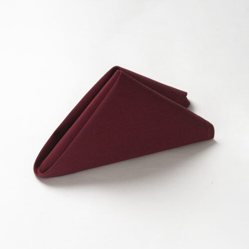 Galaxy premium burgundy red polyester cloth napkin folded in a standing pyramid shape on a clean white background.